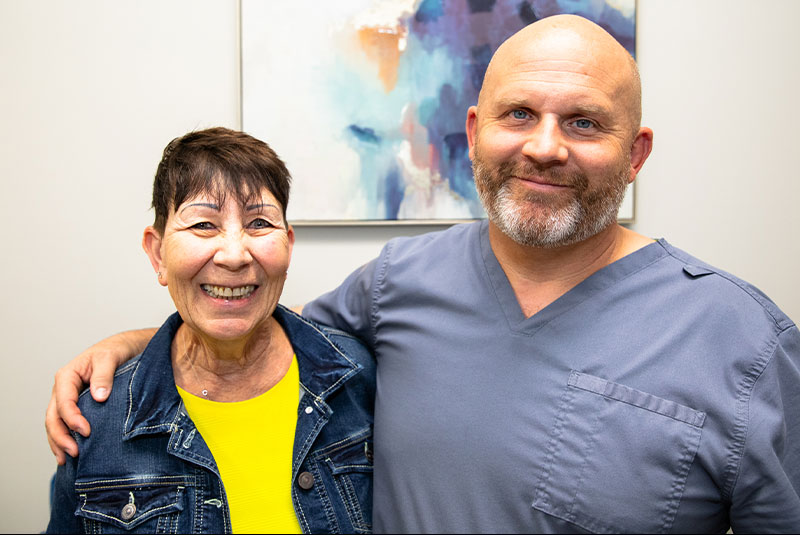 doctor and patient smiling within the dental center