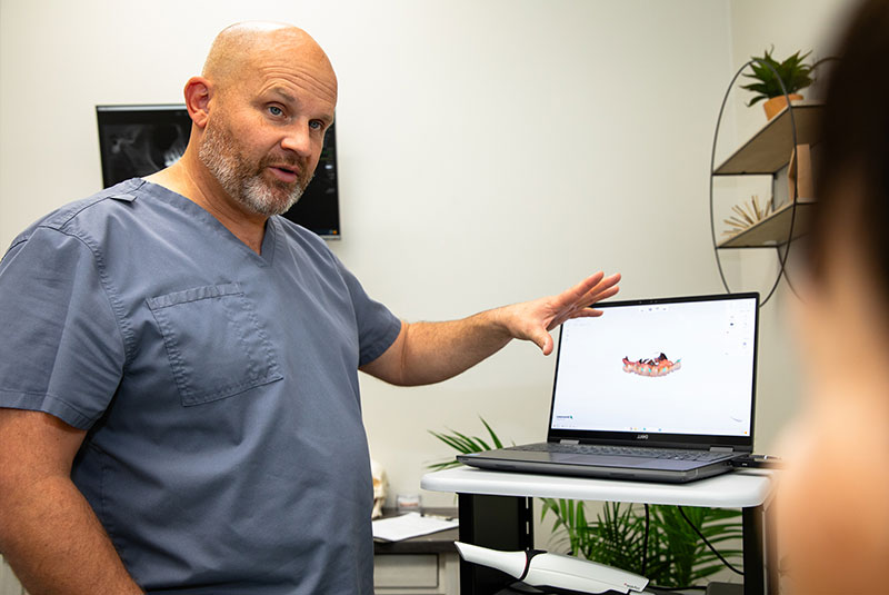 doctor going over dental procedure information with patient within the dental center