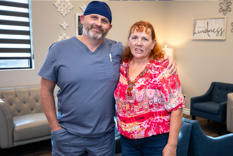 patient and doctor smiling within the dental center